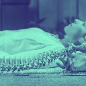 back in action olympia spinal decompresion chiropractic service LADY LAYING ON HER SIDE WITH A FAKE SPINAL CHORD ON DISPLAY NEXT TO HER