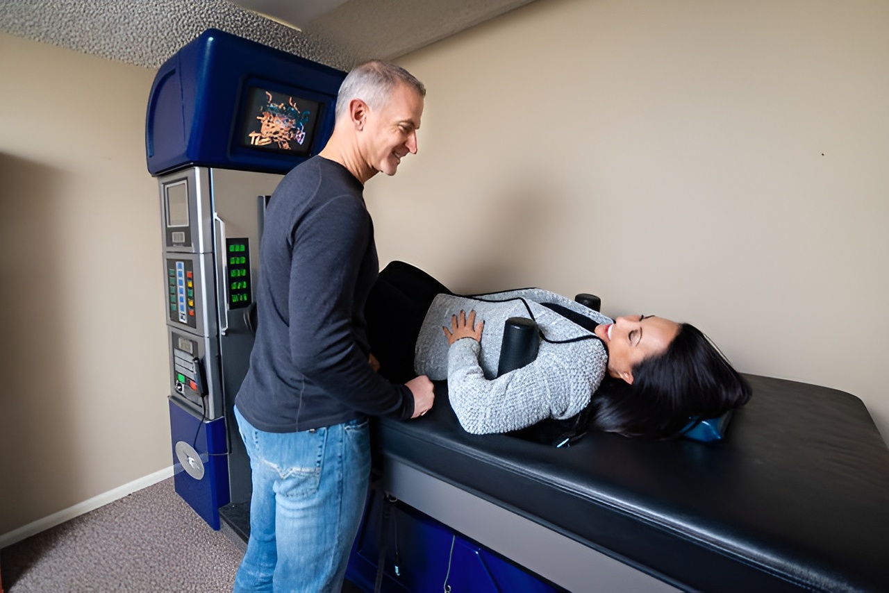 Dr. McConnell Performing Spinal Decompression Therapy on a Patient